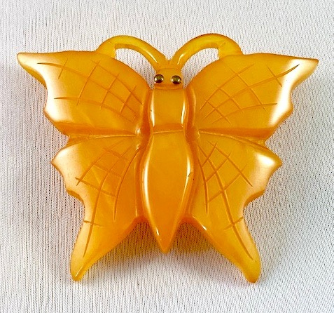 BP82 pearlized apricot bakelite butterfly pin